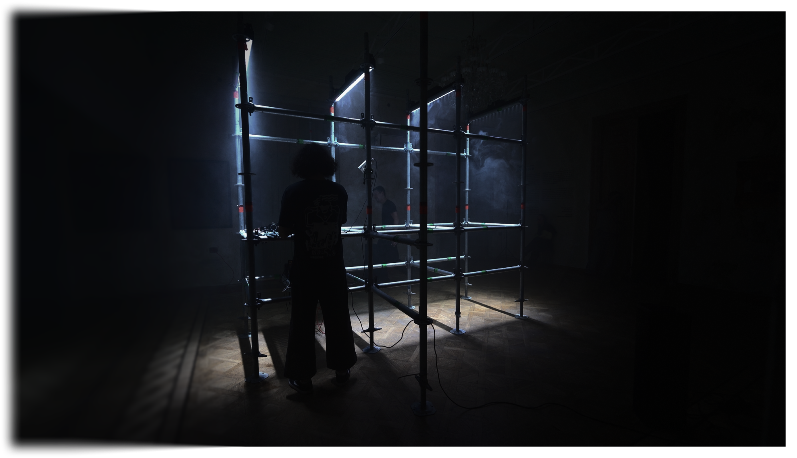 Silhouetted artist front of LED frame
